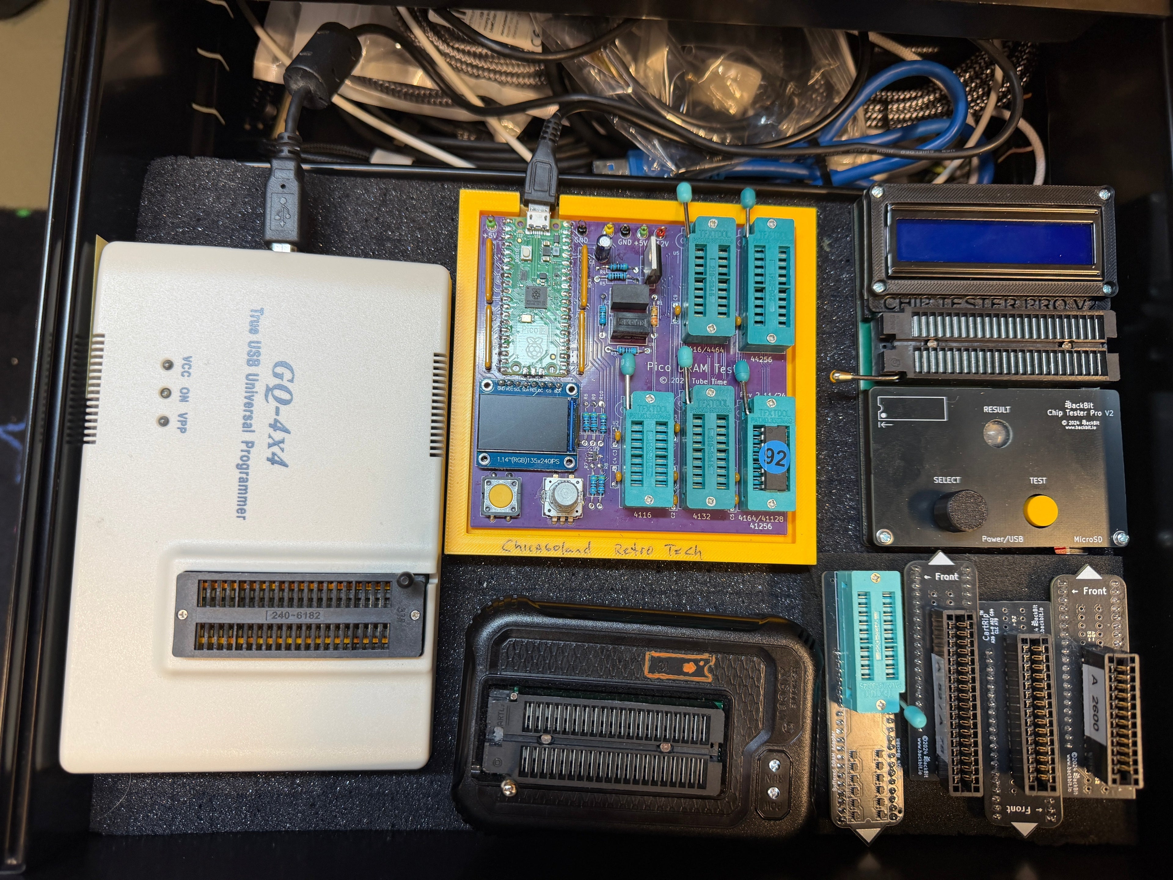 Drawer overview of the cross-validation rig: GQ-4x4, Chicagoland Retro Tech Chip Tester Pro V2, BackBit chip tester, and Atari cartridge interface adapters