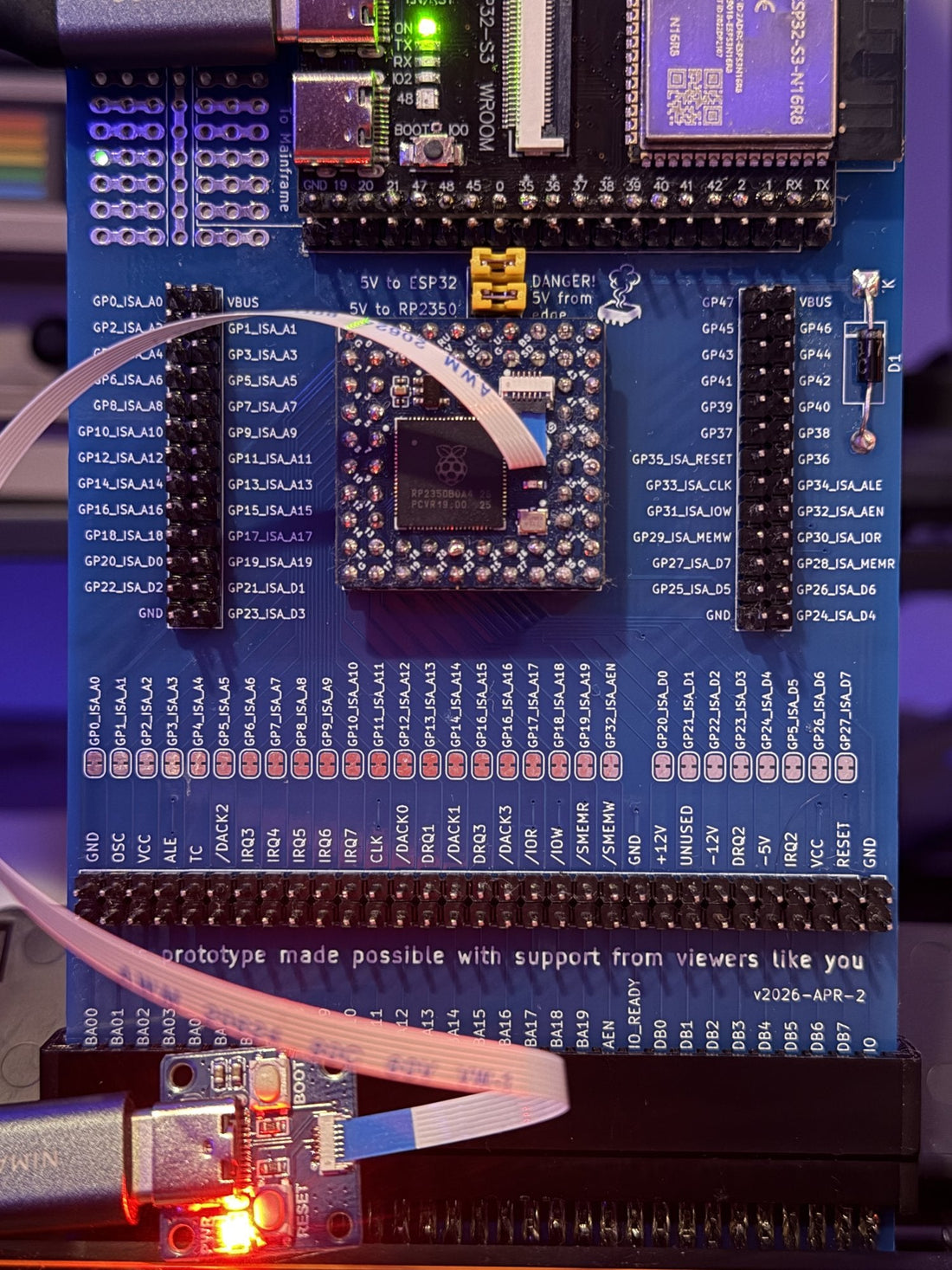 MSX FujiNet board mid-debugging in a Panasonic FS-A1, ribbon cable and flashing adapter attached.