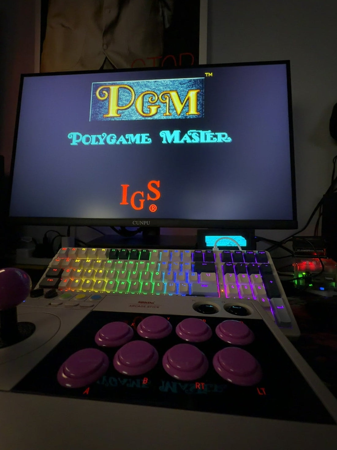 The PGM PolyGameMaster boot screen with the IGS logo, running on a MiSTer FPGA.