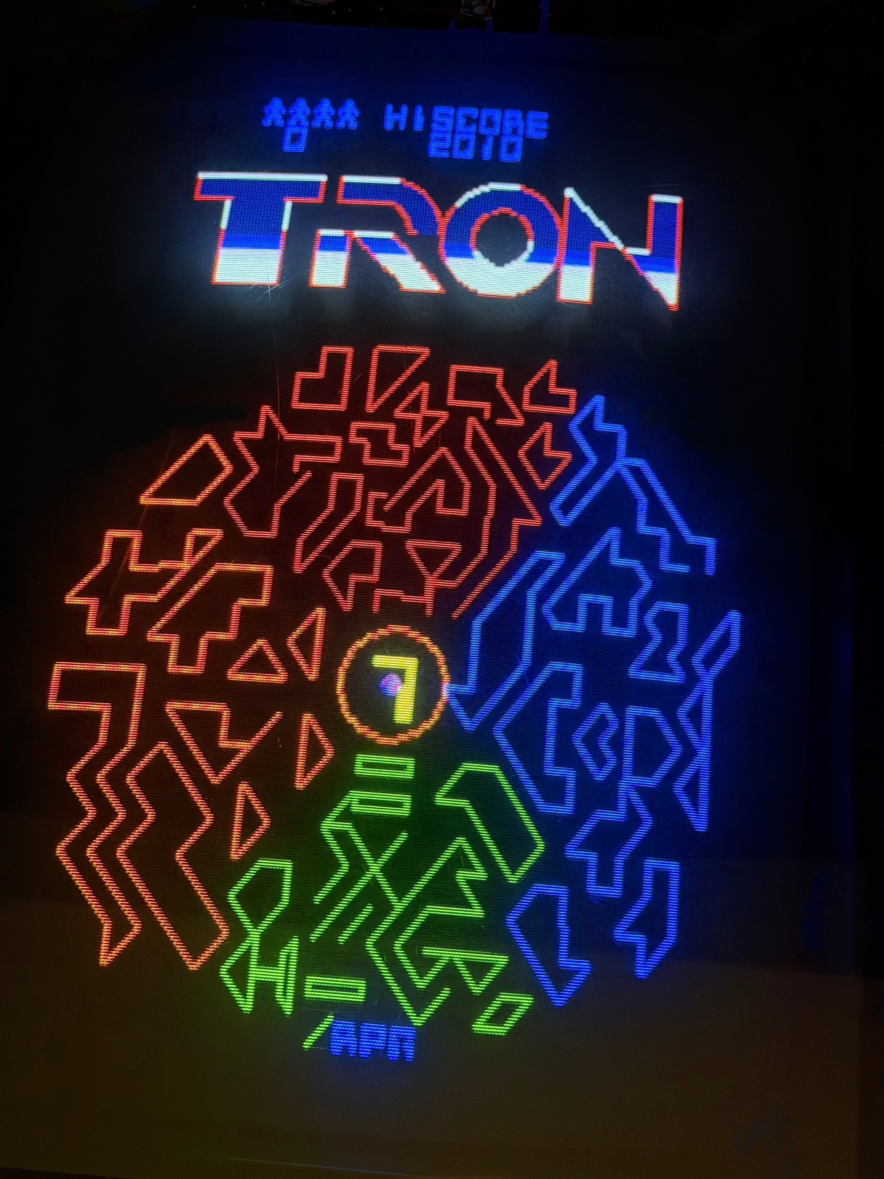 TRON 1982 arcade title screen — logo and grid maze — on a raster CRT arcade cabinet.